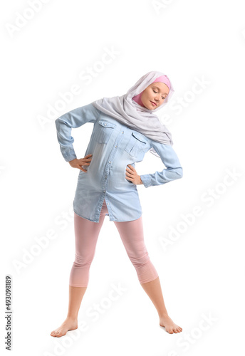 Pregnant Muslim woman doing...