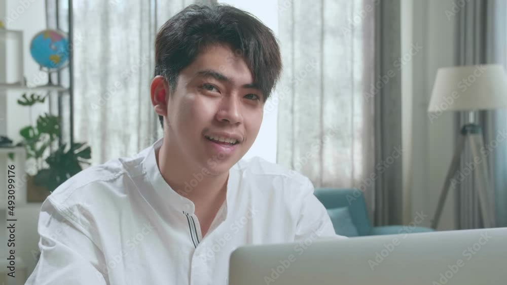 Close Up Of Asian Man Student Look At Camera And Smile While Using Computer To Study Online At Home
Close Up Of Asian Man Student Look At Camera And Smile While Using Computer To Study Online At Home