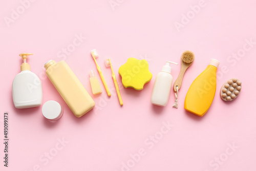 Set of cosmetic products and different bath accessories on pink background