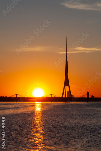 Beautiful sunset in Riga, Latvia. Daugava river. The bright sky above the water.