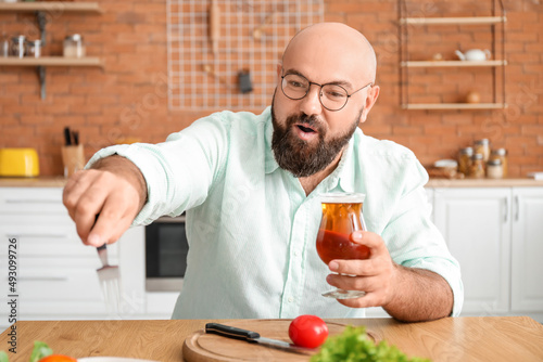 Bald man drinking beer and ...