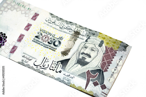 Obverse side of 200 two hundred Saudi riyals banknote features King Abdul Aziz Al Saud founder of the kingdom and a 3D logo of the nations vision 2030, Saudi Arabia money isolated on white background photo