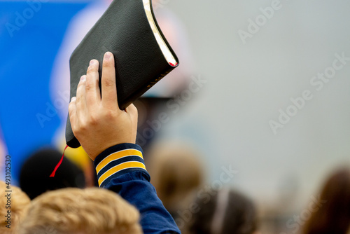 Raising a Bible in the air