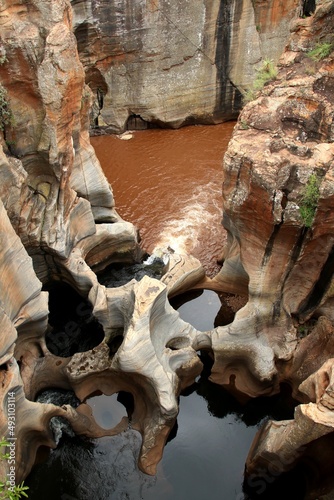 Bourke's Luck Potholes, Blyde River Canyon view to red rock formations with brown water river and some potholes