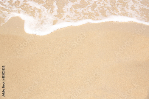 beautiful texture of sandy beach, white sea foam, building sand castles, summer vacation, fun on the beach
