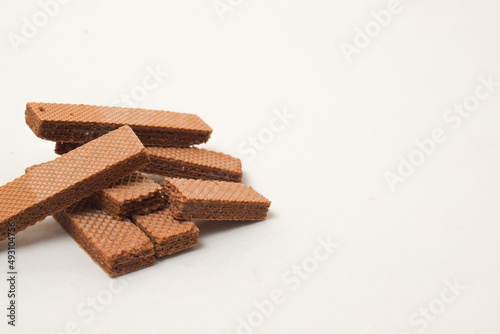 Pile of delicious chocolate wafers, on white background.