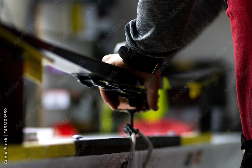 Installation of cross-country skis on the preparation machine