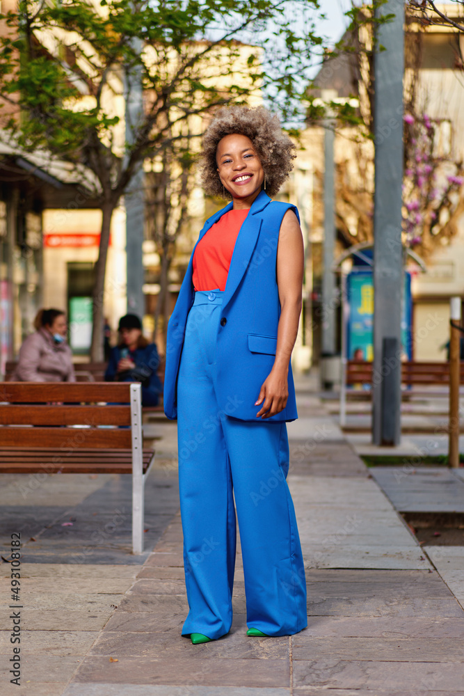 Fototapeta premium Portrait of attractive positive curly hairstyle dark skin lady smile free time outdoors