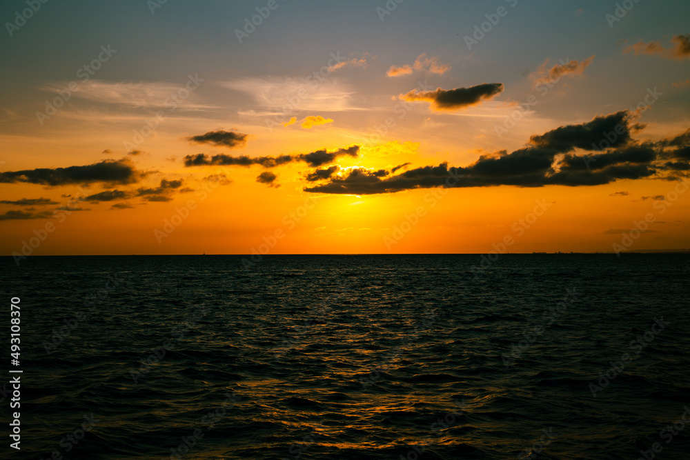 Sunset view from sea. Sunset over the sea and clouds.