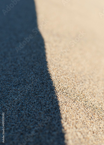 The border between light and shadow at the edge of a sand dune.