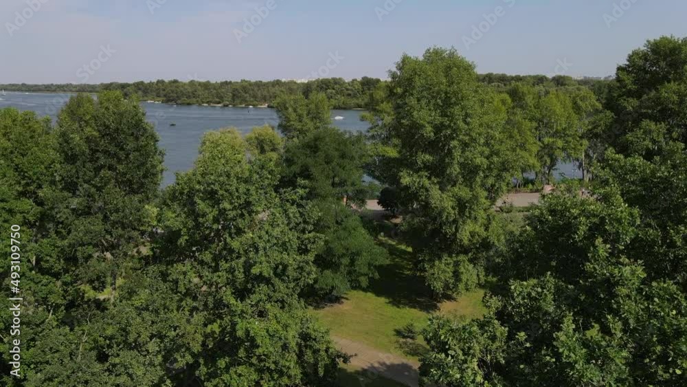 View from a height of green trees and the Dnieper River in the city of Kyiv. Video from a drone to peaceful Kyiv Ukraine View from a height of green trees and the Dnieper River in the city of Kyiv. Video from a drone to peaceful Kyiv Ukraine