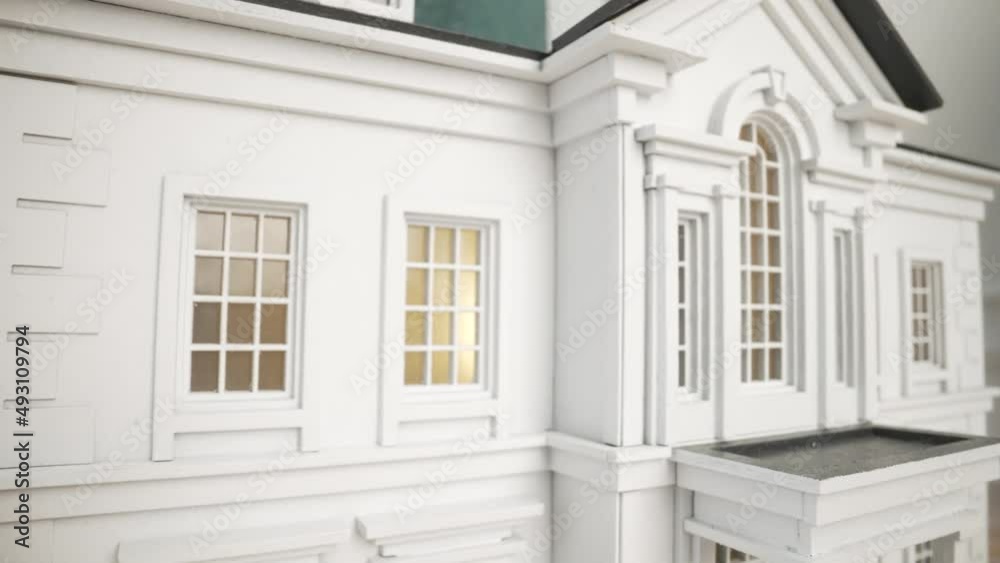 House model. The house model is painted white under a tiled roof. House model. The house model is painted white under a tiled roof.