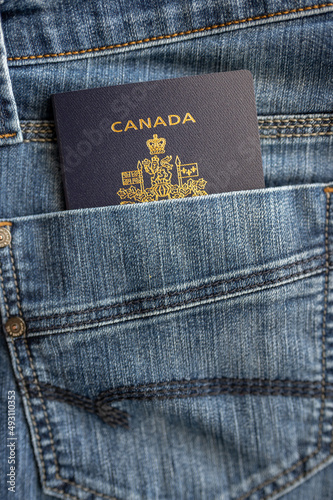 Blue jean pocket with Canadian Passport for travel concept