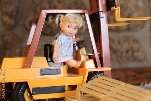 Female baby doll riding electric pallet truck