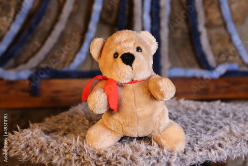 Obraz na płótnie Brown teddy bear with cool red tie