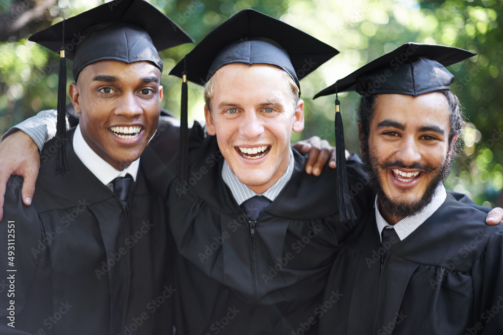 Fototapeta premium Its been tough, but weve finally made it. A group of happy male students on graduation day.