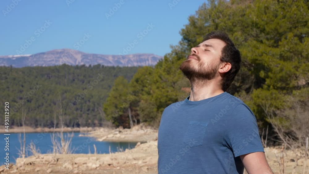Handsome man breathing in a lake fresh air Handsome man breathing in a lake fresh air
