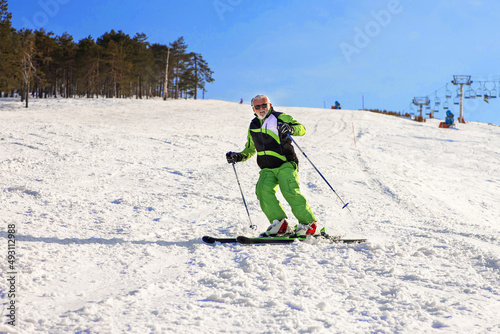 Older man skiing and enjoy on mountain covered with snow.