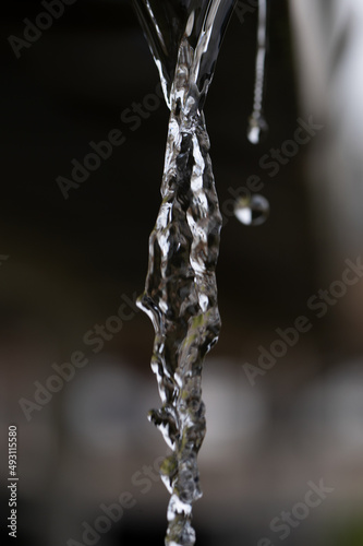 Water flowing out of a gutter drain pipe after a rain storm where the heavens opened up showing the absolute beauty in nature of each individual droplet  © Phillip