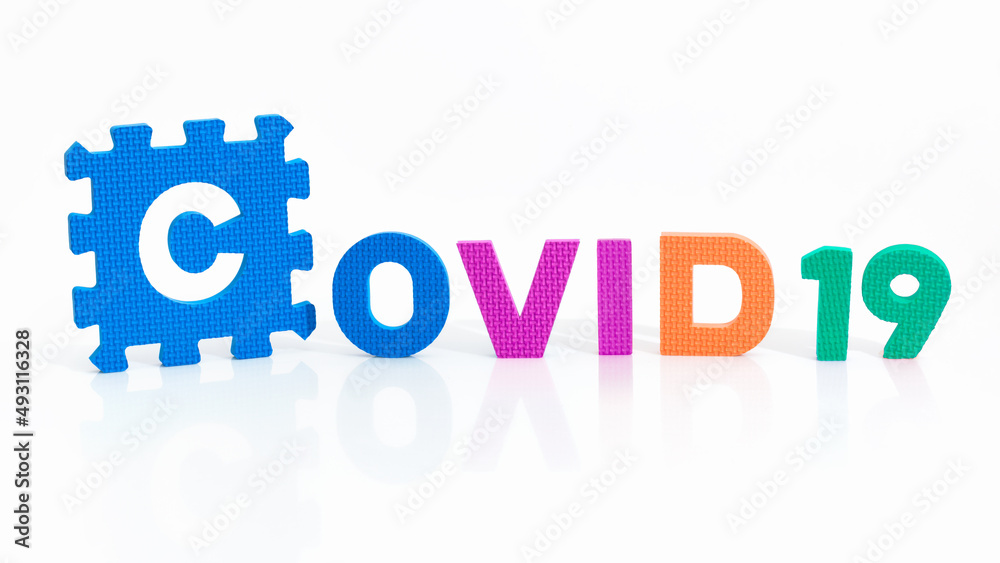 Close up on the word Covid 19 written in 3 different colors. Coronavirus pandemic and prevention vaccination campaign.