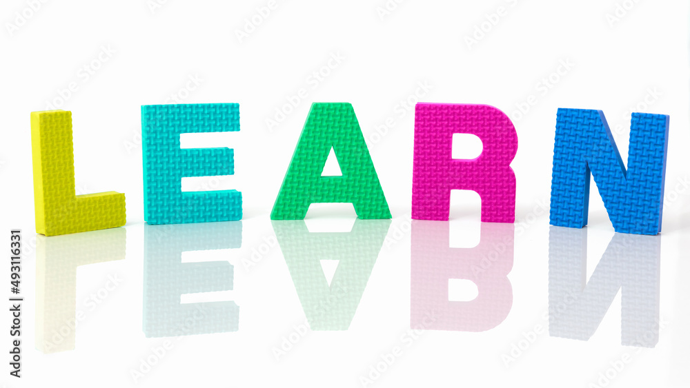 Close-up on the word learn written in different colors. Concept of learning, study and assimilation. Try to learn concept. Learning by making mistakes. Learning while having fun. Close-up on the word learn written in different colors. Concept of learning, study and assimilation. Try to learn concept. Learning by making mistakes. Learning while having fun.