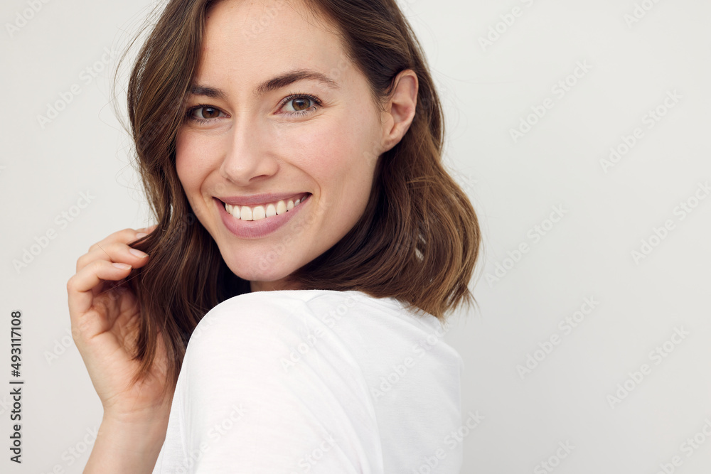 Portrait of beautiful naturally brunette woman, smiling and looking in camera with white teeth. Close-up portrait of cute female girl isolated on white background. Portrait of beautiful naturally brunette woman, smiling and looking in camera with white teeth. Close-up portrait of cute female girl isolated on white background.