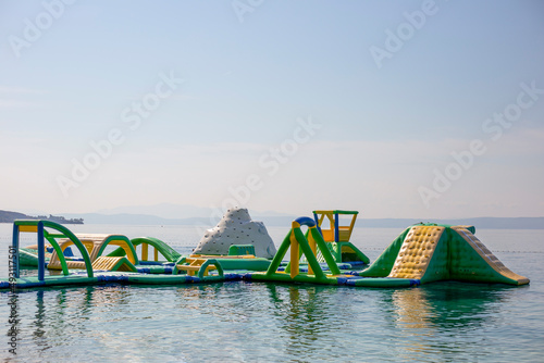 Fotografie, Obraz Inflatable trampoline for children on the water