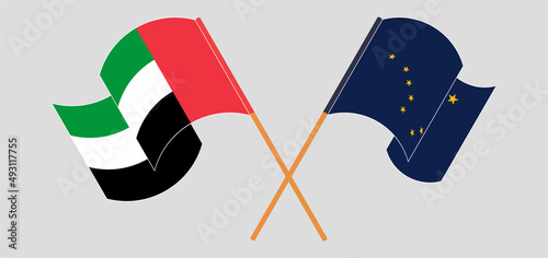 Crossed and waving flags of the United Arab Emirates and the State of Alaska