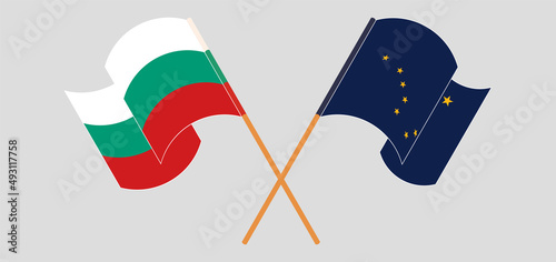 Crossed and waving flags of Bulgaria and the State of Alaska
