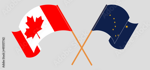 Crossed and waving flags of Canada and the State of Alaska