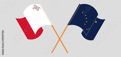 Crossed and waving flags of Malta and the State of Alaska