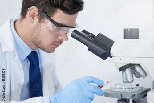 Identifying microorganisms that are causing infection. Cropped shot of a young male scientist working in his lab.