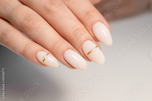 Nude manicure. Gel polish on milky nails. Almond shaped nails. Gold design nails. Beautiful manicure. 