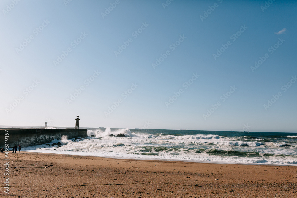 Photo of wonderful nature of shore ocean with waves and lighthouse in the ocean. Beautiful nature of Portugal ocean