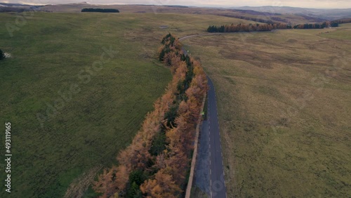 Follow Road in French Lowland at Autumn Under Cloudy Sky