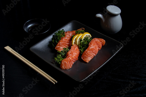 Salmon on Black Plate with Lemon and Parsley