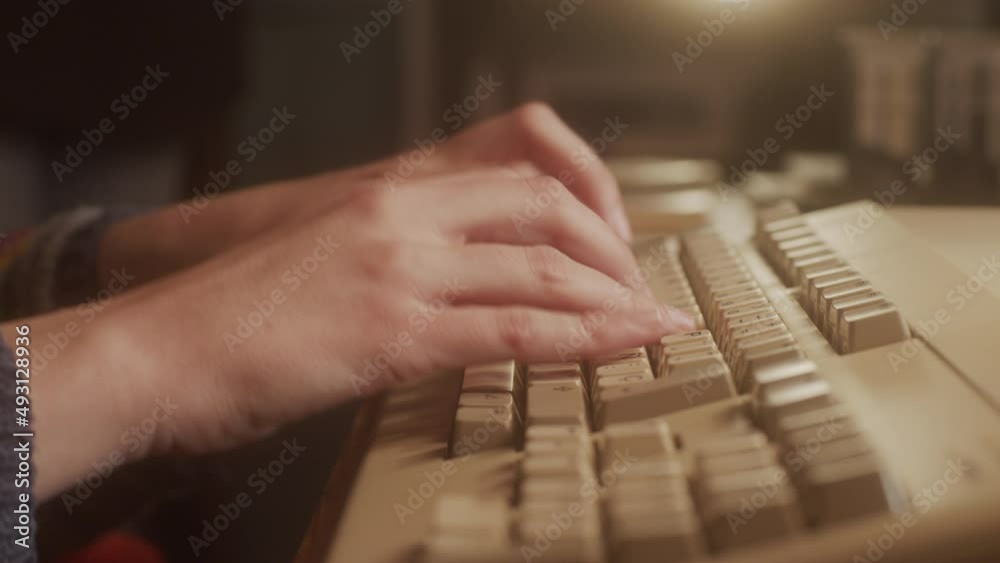 Hands typing on the keyboard of an old micro computer. Close-up. Hands typing on the keyboard of an old micro computer. Close-up.