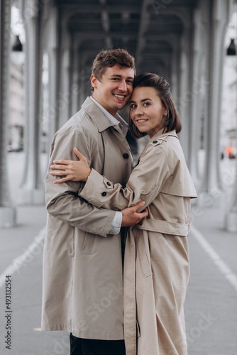 Couple In Love. Man Carrying Girl On His Back On Street. Smiling Male With Beautiful Young Woman Having Fun Spending Time Together. Relationships Concept. High Quality Image.