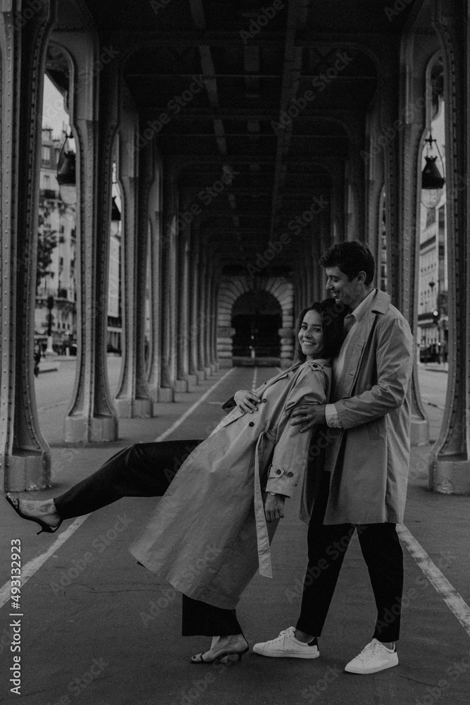 Paris Eiffel tower romantic couple embracing kissing in front of Eiffel Tower, Paris, France. Happy young interracial couple, Asian woman, Caucasian man.