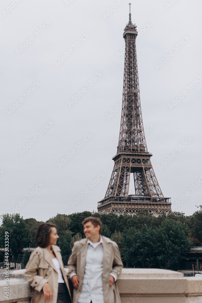 Young smiling happy european couple in the sunshine street in Paris, France