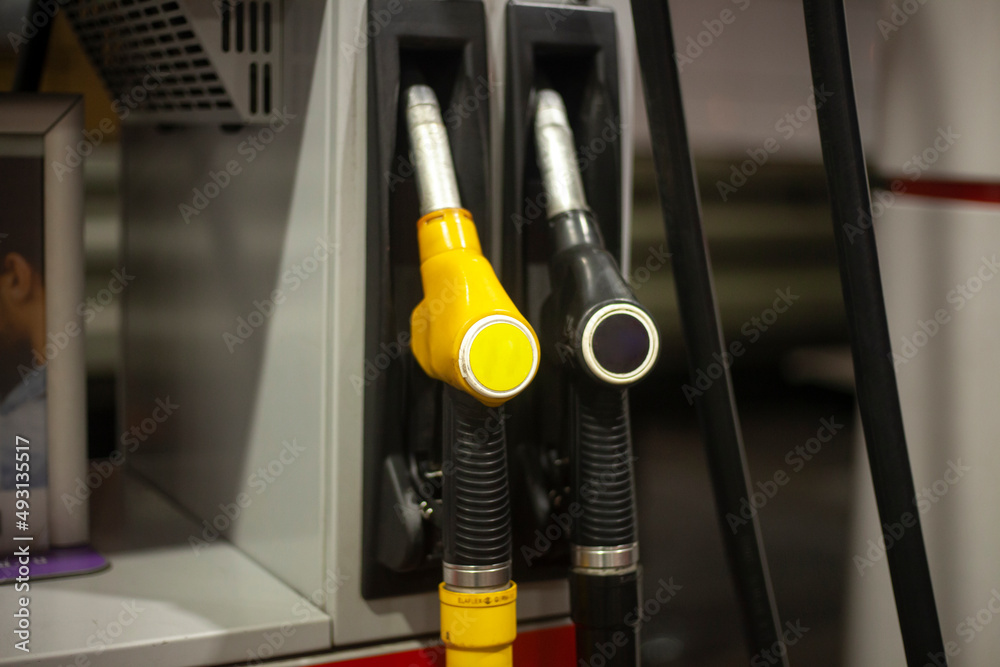 Road gas station. Hoses for refueling the machine. Petrol pump. Oil prices affected gas prices. Road gas station. Hoses for refueling the machine. Petrol pump. Oil prices affected gas prices.