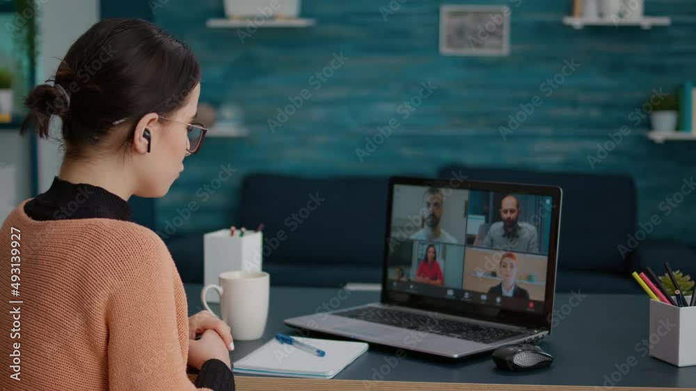 University student attending video call meeting with people on online school class, using laptop at home. Woman having conversation on remote teleconference, webinar learning chat. University student attending video call meeting with people on online school class, using laptop at home. Woman having conversation on remote teleconference, webinar learning chat.
