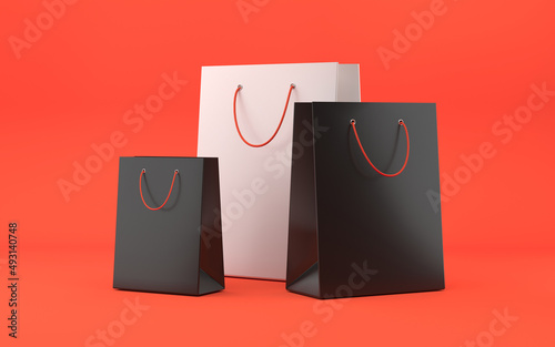 Shopping bags with ropes. Black and white paper bags on red background. Purchase concept. 3d rendering