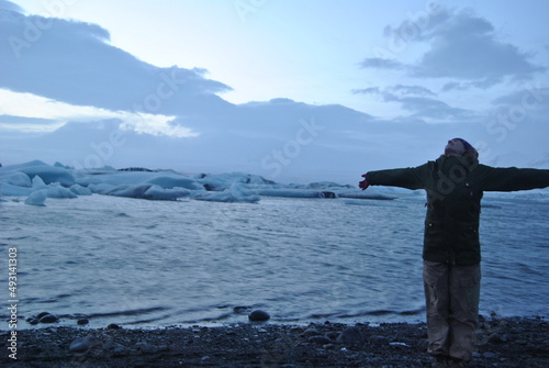 person in a Iceland lake in winter with glacier background