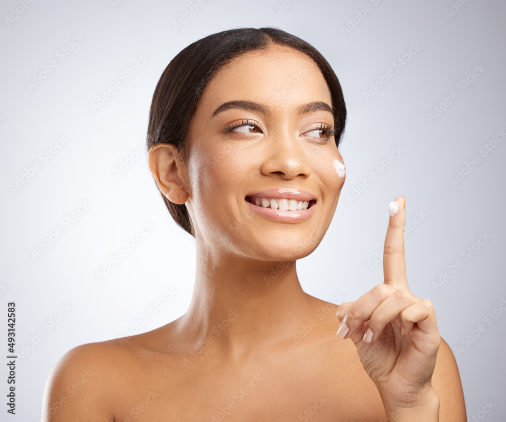 This moisturiser makes dry skin a distant memory. Studio shot of an attractive young woman applying moisturiser to her face against a grey background. This moisturiser makes dry skin a distant memory. Studio shot of an attractive young woman applying moisturiser to her face against a grey background.