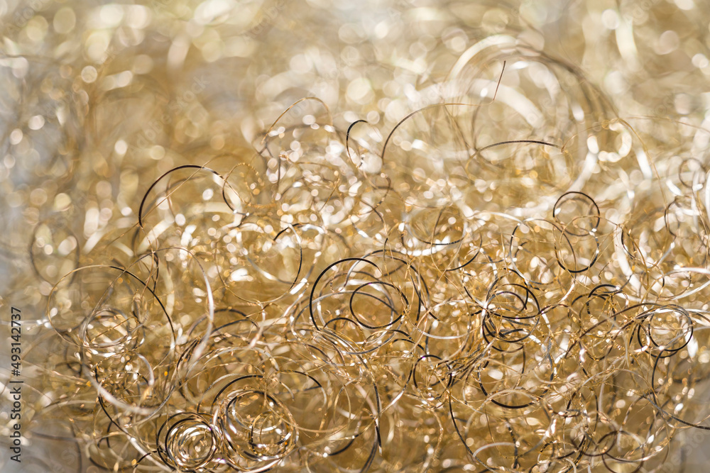 The light gold variant of metal angel hair. Christmas decorative material with bokehed background Stock Photo | Adobe Stock The light gold variant of metal angel hair. Christmas decorative material with bokehed background Stock Photo | Adobe Stock