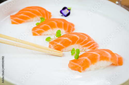 Delicious premium salmon nigiri on white handmade plate