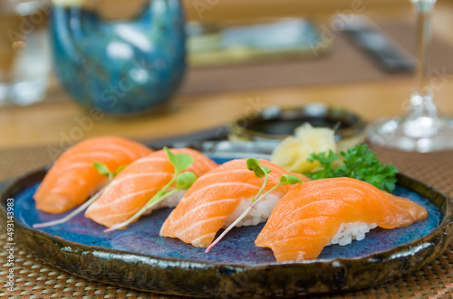 Delicious premium salmon nigiri on blue plate