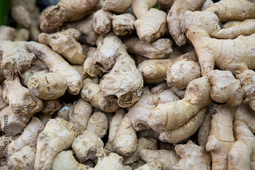 Fresh ginger root on showcase of greengrocery shop for sale to customers