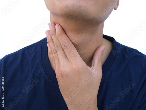 Asian men have a sore throat caused by laryngitis. closeup photo, blurred.